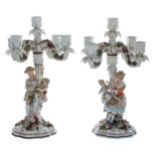 Pair of Sitzendorf porcelain five-branch candelabra, the scrolled arms encrusted with flowers,