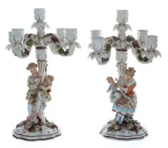 Pair of Sitzendorf porcelain five-branch candelabra, the scrolled arms encrusted with flowers,