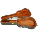 Old acoustic guitar hard case, with black exterior and orange interior
