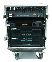 Heavy duty rack flight case enclosing a pair of Peavey PV-8.5C power amplifiers, a Yamaha CP2000