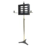Victorian duet adjustable music stand, the ebonised ledges fitted with two folding candle sconces,