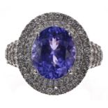 Large and impressive 18ct white gold ring, set with a large oval tanzanite surrounded by a double