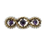 Attractive 14ct rope twist design brooch, with three cabouchon amethyst and a seed pearl border, 7.