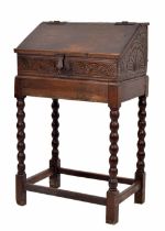 17th century and later oak table writing box on stand, with sloped hinged cover enclosing an open