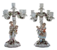 Pair of Sitzendorf porcelain five-branch candelabra, the scrolled arms encrusted with flowers,