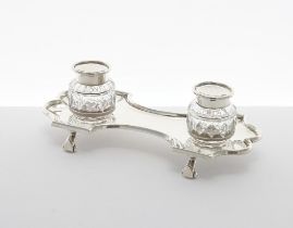 Late Victorian silver desk inkstand, the shaped and lobed stand raised on four scroll feet with