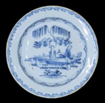 Delft blue and white pottery plate, decorated with a figure in a garden under a tree, within