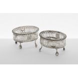 Pair of Georgian silver open salts, the pierced oval baskets raised on four claw and ball feet