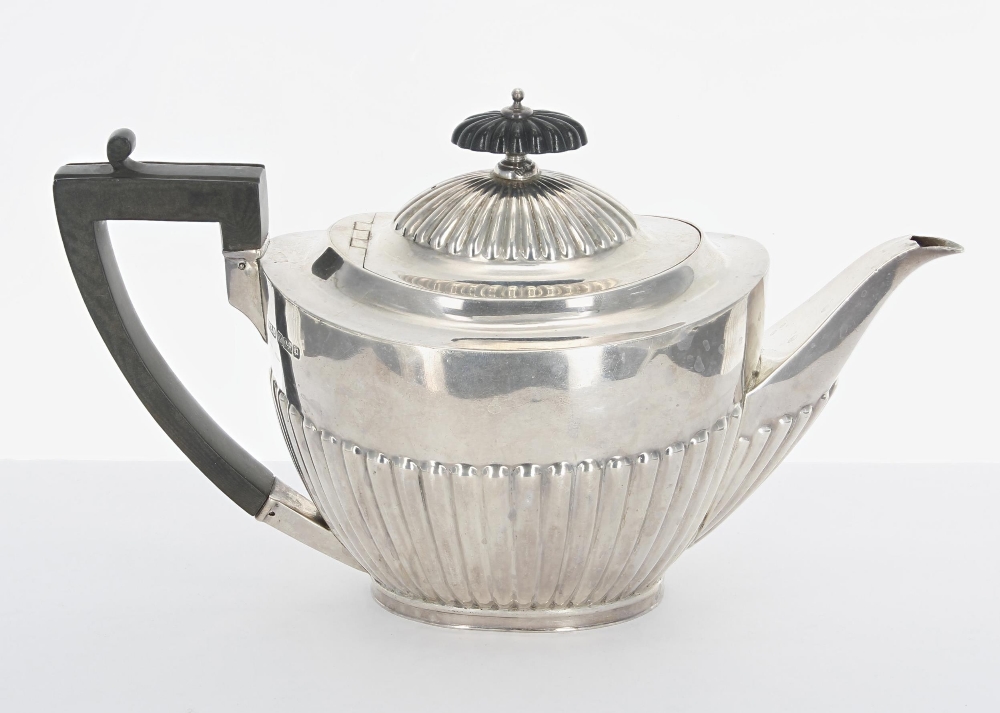 Edwardian silver teapot, with a hardwood handle and finial over a half reeded body, maker
