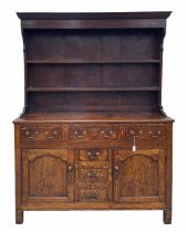18th century Welsh oak dresser, the closed shelved back over a base of three short drawers above