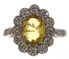 Good 18ct and platinum yellow sapphire and diamond oval cluster ring with set shoulders, the