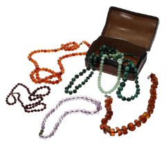 Two malachite graduated bead necklaces, 24" 22" long respectively; carnelian bead necklace, amber