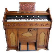 Good small walnut harmonium bearing the retailer's sticker above the keyboard inscribed Manufactured