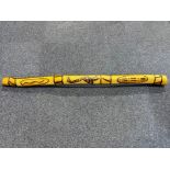 Australian Carved Wood Didgeridoo, decorated with carvings of kangaroos and snakes.