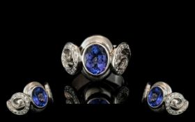 18ct White Gold Sapphire & Diamond Designer Ring, set with a central oval cut Sapphire between two