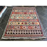 An Aztec Design Woolen Rug, Multi Coloured Ground, Geometric Black And White Border, 280 x 195 cm.