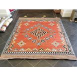 An Aztec Design Woolen Rug, Salmon Ground, Bright Geometric Decoration, 310 x 250 cm.