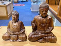 Two Oriental Wooden Carved Buddhas with good detail, measuring 21" and 17" high.