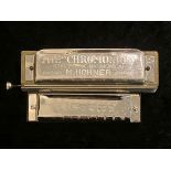 M Hohner 'The Chromonica' Harmonica, made in Germany, together with a Victory Harmonica.