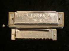 M Hohner 'The Chromonica' Harmonica, made in Germany, together with a Victory Harmonica.