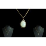 9ct Gold Attractive Opal Set Pendant Attached to a 9ct Gold Chain. Both Marked for 9.375.