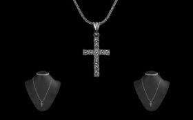 An 18ct White Gold Diamond Set Cross with Attached 18ct White Gold Chain both marked 750 - 18ct.