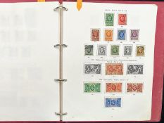 Stamp interest: Red Stanley Gibbons loose leaf illustrated GB stamp album - Partially filled with