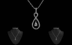 18ct White Gold Diamond Set Pendant In a Figure of Eight Design and Matching 18ct Gold Chain,