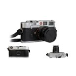 A Leica M6 Camera, chrome, Leica Germany, serial no 2002525, Comes With Camera Case And Two Lenses,
