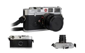 A Leica M6 Camera, chrome, Leica Germany, serial no 2002525, Comes With Camera Case And Two Lenses,