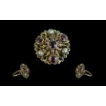 An Antique Austro Hungarian Style Ring set with baroque pearls and garnets, some enamelling,