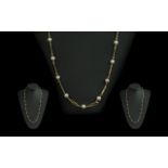 18ct Gold Attractive Necklace set with cultured pearl spacers, marked 750 - 18ct; weight 15.
