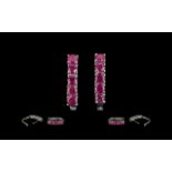 Ruby J-Hoop Earrings, each earring having five round cut, warm red rubies, closely set in a single,