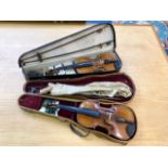 Two Violins in Cases, one in black case with accessories,