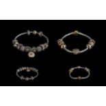Pandora Signed Pair of Sterling Silver Charm Bracelets loaded with 18 Pandora charms,