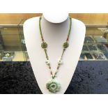 Green Jade Carved Flower Pendant Necklace, the necklace comprising carved multicolour jade beads and