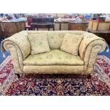 Edwardian Drop Arm Two Seater Sofa, damask fabric upholstery. Short cabriole legs and casters.