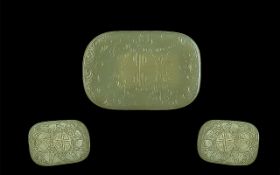 Chinese Jade Amulet of oval disc form, engraved decoration. Measures 3" x 2".