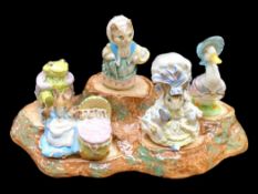 Five Beswick Beatrix Potter Figures, housed on a porcelain stand, figures comprising Mr.