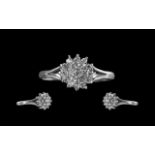 18ct White Gold Attractive Diamond Set Cluster Ring, flowerhead setting. Marked 18ct to interior