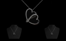18ct White Gold Diamond Heart Shaped Pendant suspended on a fine box link chain.