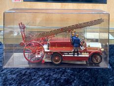 A Diecast Model of a 1914 Dennis Fire Engine, housed in a perspex box,