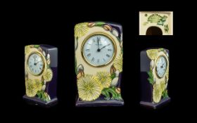 Moorcroft Modern Tube lined Table Clock. Date 2008. ' Daisy's ' Design on Cream and Blue Ground.