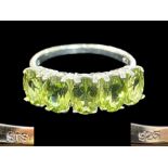 Peridot Half Eternity Ring, five oval cut, bright, sparkling peridots, totalling 4cts,