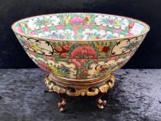 An Oriental Floral Decorated Bowl, 9" diameter, marked Empire to base, on carved wooden stand.
