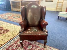 Oxblood Leather Chesterfield Style Armchair, studded edges, raised on short cabriole legs.