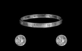 18ct White Gold Attractive Cartier Style Diamond Set Bangle, set with 10 brilliant cut diamonds of