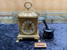 Brass Chiming Mantle Clock, embossed pattern, fist holding handle, Roman numerals.