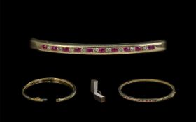 10ct Gold - Attractive Ruby and Diamond Set Hinged Bangle. Marked 10ct.