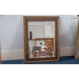 Large Antique Mirror with decorative wooden frame, bevelled glass edges, measures approx 38" x 32".